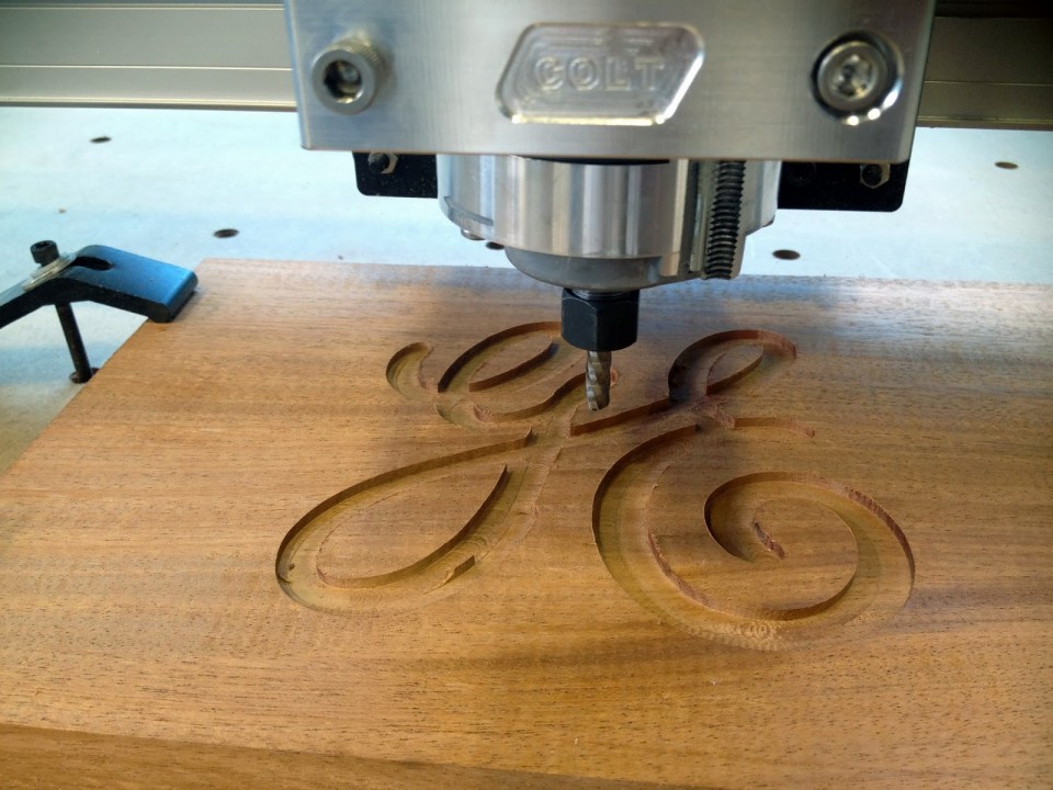 cnc router carving a monogram into wood